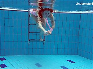 ginger-haired Simonna demonstrating her figure underwater